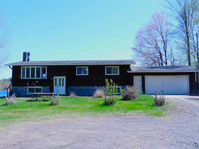 8305 Half Moon Dr, Iron River, WI 54847 - view of front facade with a chimney, driveway, and an attached garage