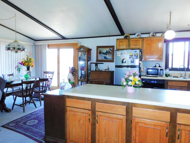 8305 Half Moon Dr, Iron River, WI 54847 - kitchen featuring appliances with stainless steel finishes, a sink, brown cabinetry, light countertops, and pendant lighting