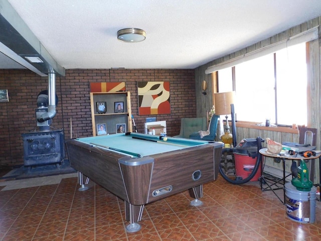 8305 Half Moon Dr, Iron River, WI 54847 - recreation room with a wood stove, brick wall, and pool table