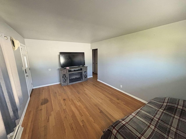 8210 W Winfield Ave, Milwaukee, WI 53218 - unfurnished living room featuring baseboards and wood finished floors