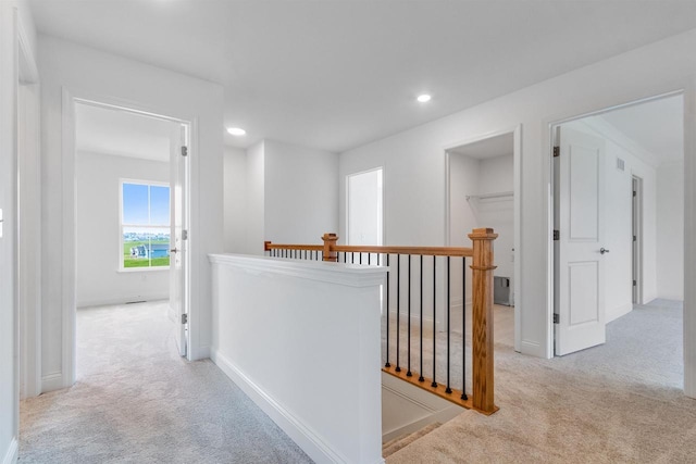 corridor featuring an upstairs landing, carpet, recessed lighting, and baseboards