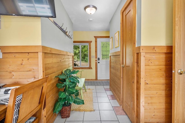 N5101 Hemlock St, Poynette, WI 53955 - doorway featuring light tile patterned flooring, wainscoting, and wood walls