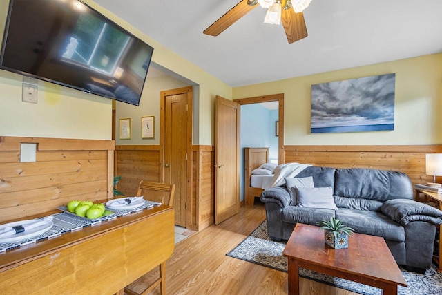 N5101 Hemlock St, Poynette, WI 53955 - living area featuring wainscoting, light wood finished floors, ceiling fan, and wooden walls