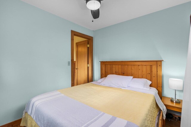 N5101 Hemlock St, Poynette, WI 53955 - bedroom featuring wood finished floors, a ceiling fan, and baseboards