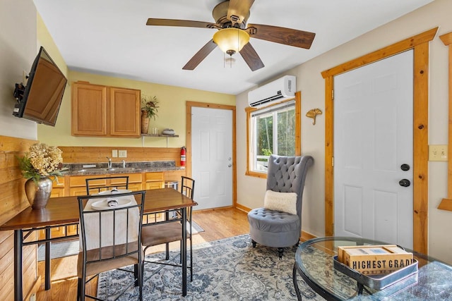 N5101 Hemlock St, Poynette, WI 53955 - dining area with a wall unit AC, light wood-type flooring, ceiling fan, and baseboards
