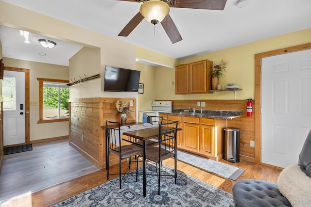 N5101 Hemlock St, Poynette, WI 53955 - kitchen with white range with electric cooktop, light wood-style flooring, dark countertops, and ceiling fan
