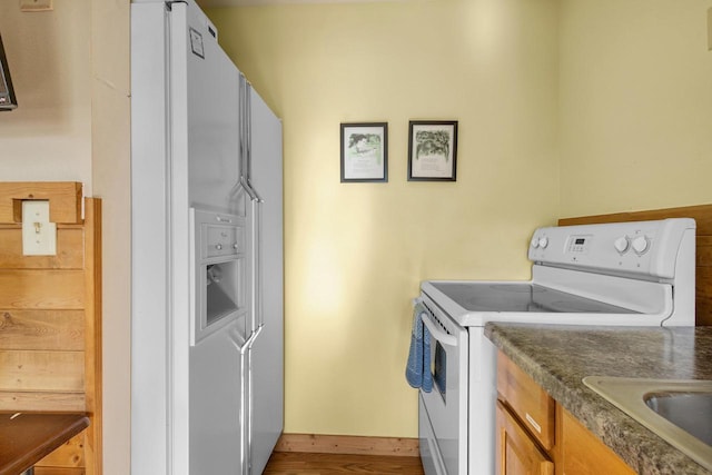 N5101 Hemlock St, Poynette, WI 53955 - kitchen with white appliances, a sink, and brown cabinets
