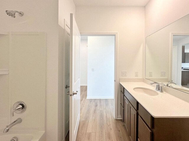 2833 Jackson St, Stoughton, WI 53589 - bathroom with wood finished floors, vanity, bathtub / shower combination, and baseboards