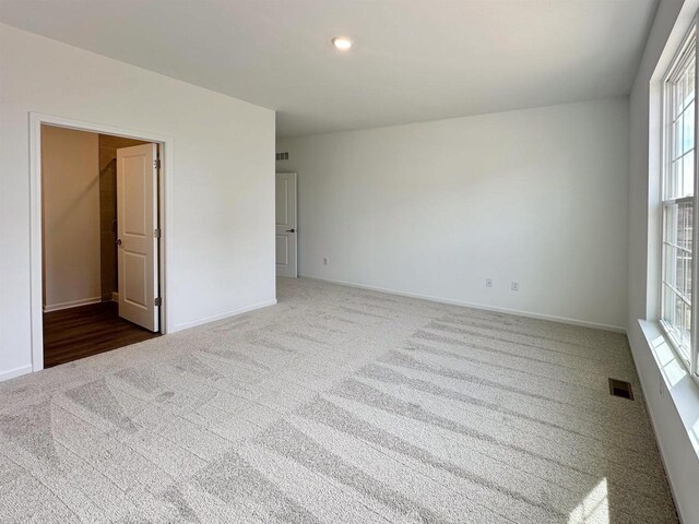 2833 Jackson St, Stoughton, WI 53589 - unfurnished room featuring dark carpet, baseboards, and recessed lighting