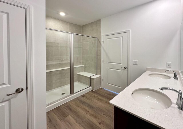 2833 Jackson St, Stoughton, WI 53589 - bathroom with a stall shower, wood finished floors, and double vanity
