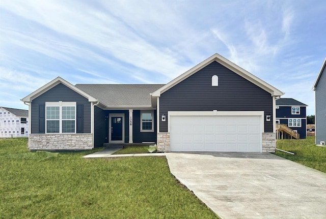 2833 Jackson St, Stoughton, WI 53589 - single story home featuring stone siding, concrete driveway, a garage, and a front lawn