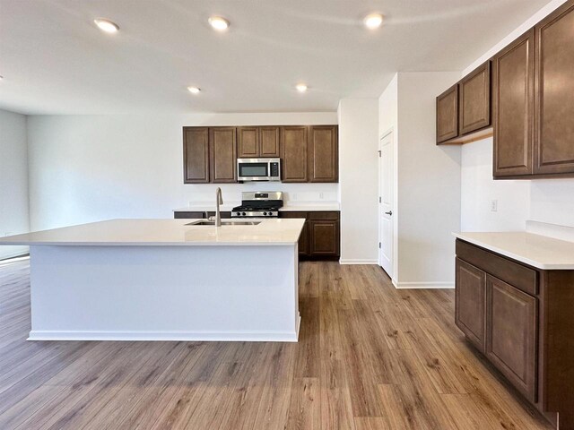 2833 Jackson St, Stoughton, WI 53589 - kitchen with stainless steel appliances, a sink, light countertops, light wood-style floors, and recessed lighting