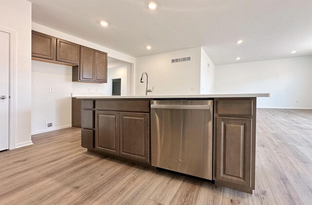 2833 Jackson St, Stoughton, WI 53589 - kitchen featuring dishwasher, light wood-style floors, a center island with sink, light countertops, and recessed lighting
