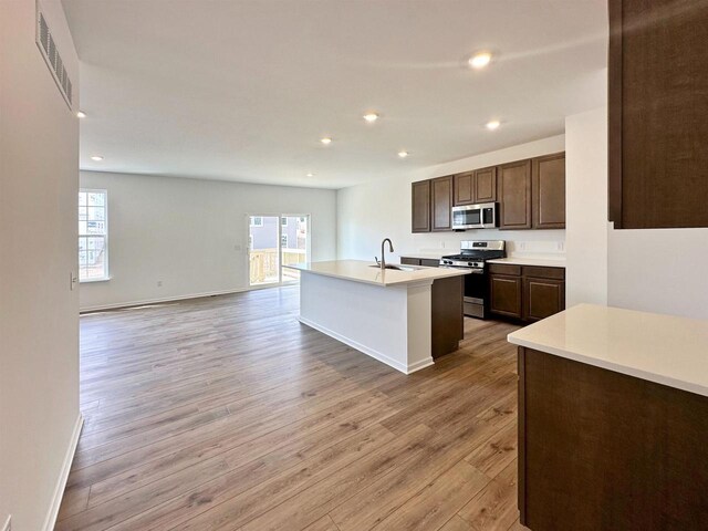 2833 Jackson St, Stoughton, WI 53589 - kitchen with appliances with stainless steel finishes, healthy amount of natural light, light wood-style floors, open floor plan, and recessed lighting