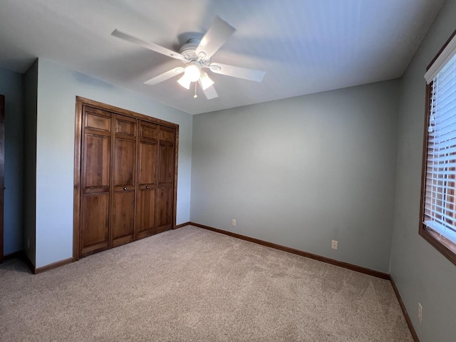 1012 Silent Sunday Ct, Racine, WI 53402 - unfurnished bedroom featuring light carpet, baseboards, a ceiling fan, and a closet