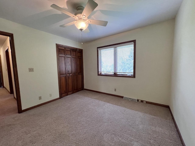 1012 Silent Sunday Ct, Racine, WI 53402 - unfurnished bedroom with light colored carpet, a closet, baseboards, and a ceiling fan