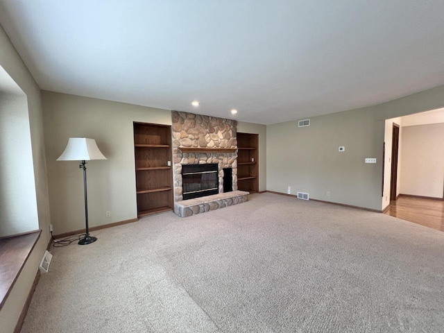1012 Silent Sunday Ct, Racine, WI 53402 - unfurnished living room with light carpet, baseboards, a fireplace, built in features, and recessed lighting