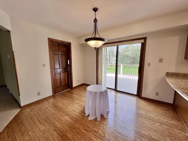1012 Silent Sunday Ct, Racine, WI 53402 - dining space featuring light wood-type flooring and baseboards