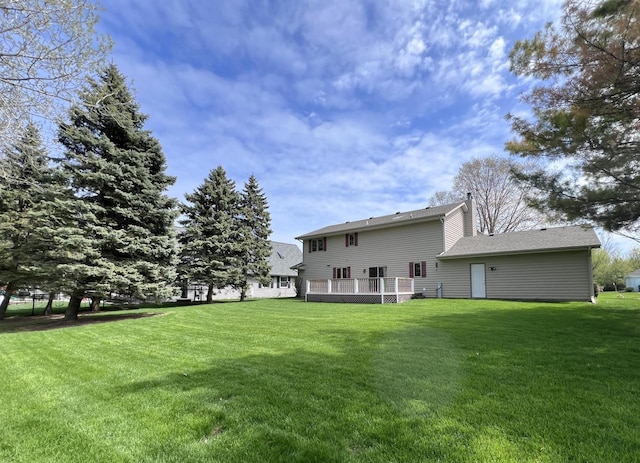 1012 Silent Sunday Ct, Racine, WI 53402 - back of property with a lawn, a chimney, and a deck