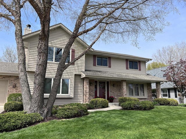 1012 Silent Sunday Ct, Racine, WI 53402 - view of front of home with a front yard, brick siding, and a chimney