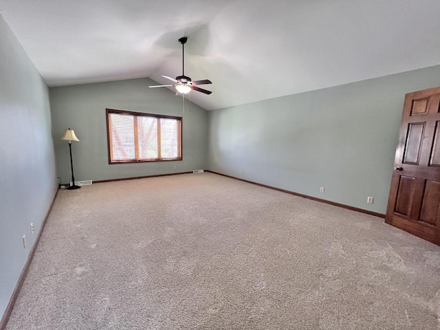 1012 Silent Sunday Ct, Racine, WI 53402 - carpeted empty room featuring a ceiling fan, vaulted ceiling, and baseboards
