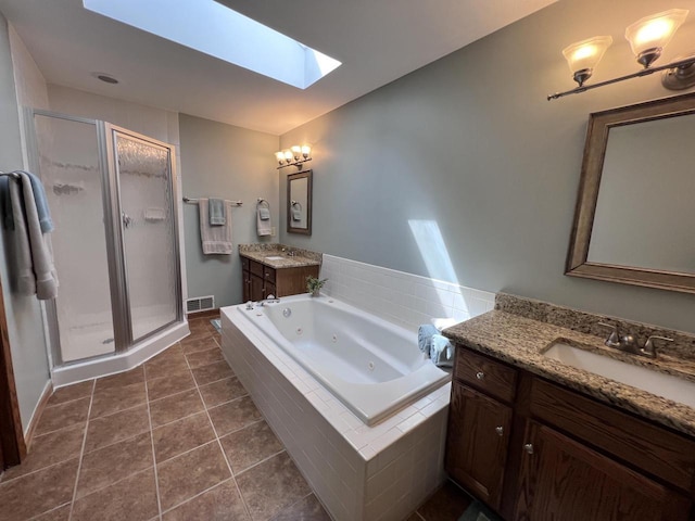1012 Silent Sunday Ct, Racine, WI 53402 - full bathroom featuring a skylight, a stall shower, a tub with jets, two vanities, and tile patterned flooring