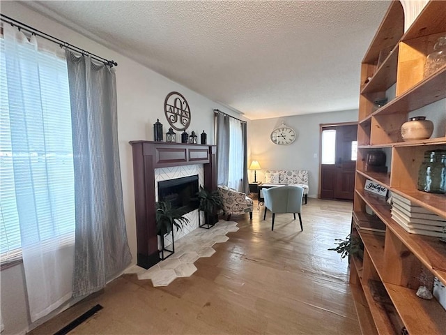 806 W Elm St, Chippewa Falls, WI 54729 - sitting room with a high end fireplace, a textured ceiling, and light wood-type flooring