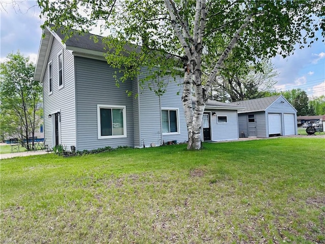 806 W Elm St, Chippewa Falls, WI 54729 - back of property with a garage and a lawn