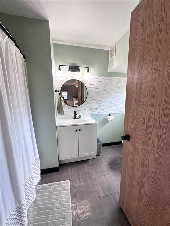 806 W Elm St, Chippewa Falls, WI 54729 - bathroom with tasteful backsplash and vanity