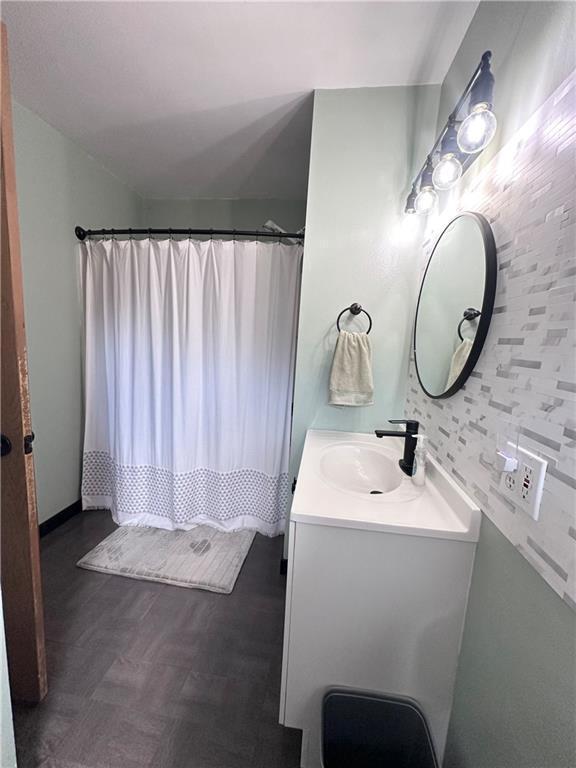 806 W Elm St, Chippewa Falls, WI 54729 - full bath with vanity, a shower with curtain, and wood finished floors