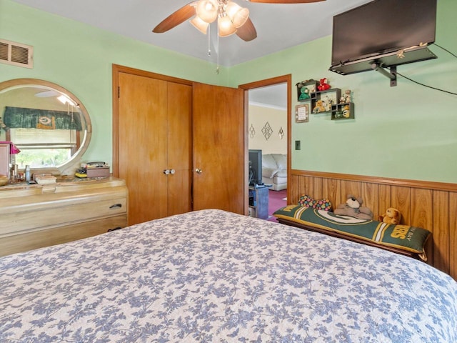 6043 N 118th St, Milwaukee, WI 53225 - bedroom with wainscoting, a closet, and ceiling fan
