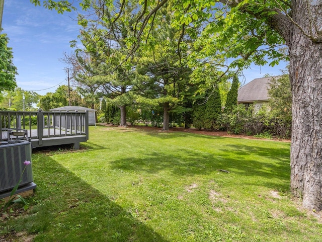 6043 N 118th St, Milwaukee, WI 53225 - view of grassy yard featuring central AC unit and a deck