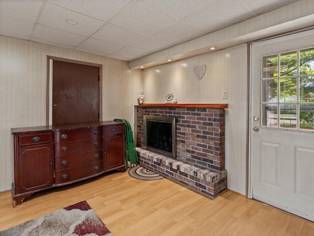6043 N 118th St, Milwaukee, WI 53225 - living room with light wood-style flooring, a fireplace, and a drop ceiling
