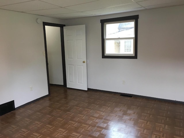 6121 12th Ave, Kenosha, WI 53143 - empty room featuring a drop ceiling and baseboards