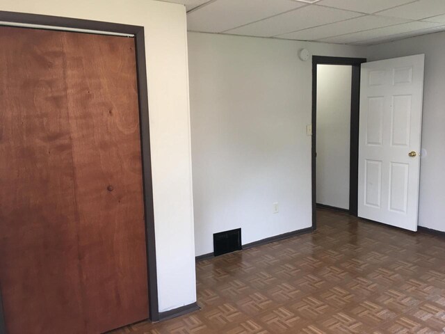 6121 12th Ave, Kenosha, WI 53143 - unfurnished bedroom featuring baseboards and a paneled ceiling