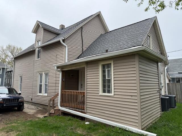 6121 12th Ave, Kenosha, WI 53143 - rear view of property with a shingled roof and cooling unit