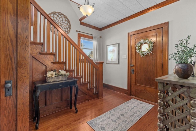 61 N Grand St, Markesan, WI 53946 - foyer featuring crown molding, wood finished floors, stairway, and baseboards