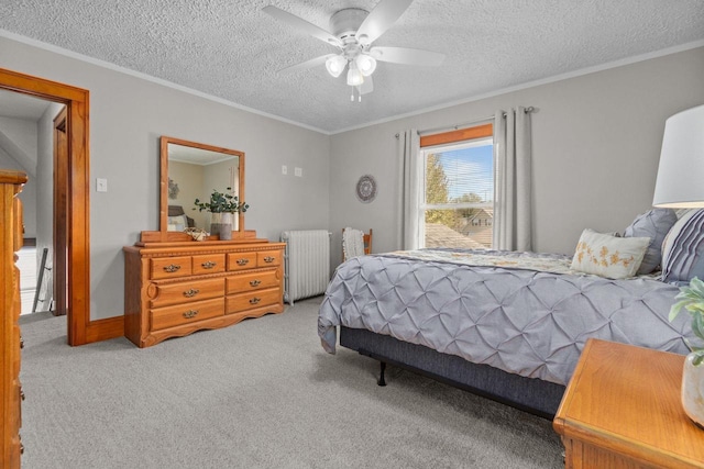 61 N Grand St, Markesan, WI 53946 - carpeted bedroom featuring radiator heating unit, crown molding, ceiling fan, and a textured ceiling