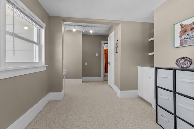 61 N Grand St, Markesan, WI 53946 - hall with light carpet, track lighting, and baseboards
