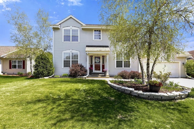 traditional home featuring a front yard, a garage, and concrete driveway
