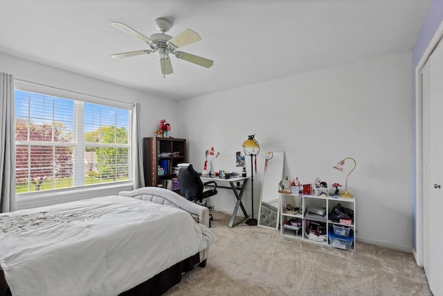 bedroom featuring carpet flooring, ceiling fan, baseboards, and a closet