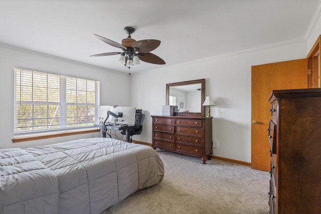 carpeted bedroom featuring crown molding, baseboards, and ceiling fan