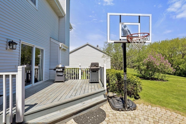 wooden deck with a grill and a yard