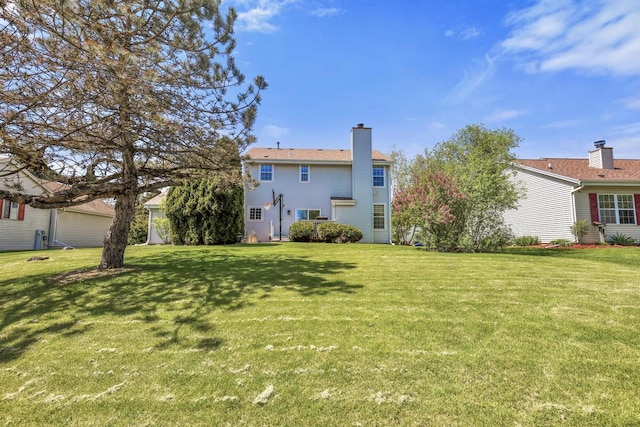 back of property featuring a yard and a chimney