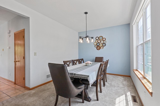dining room featuring a chandelier, baseboards, and light tile patterned flooring