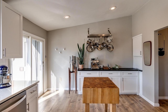5402 Comanche Way, Madison, WI 53704 - kitchen with light wood-style floors, white cabinetry, recessed lighting, dishwasher, and baseboards