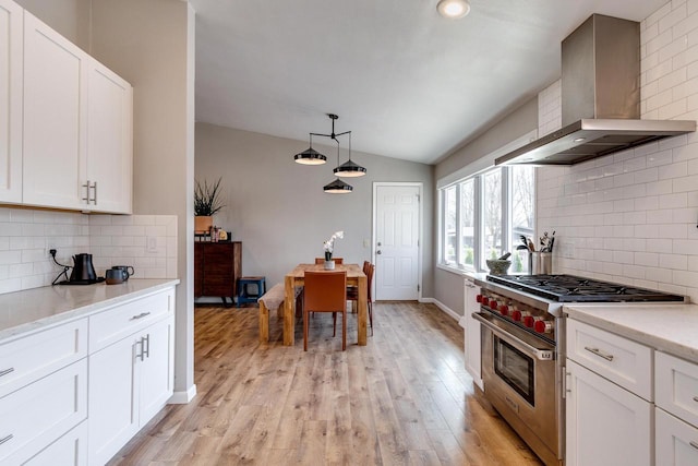 5402 Comanche Way, Madison, WI 53704 - kitchen with designer range, wall chimney exhaust hood, lofted ceiling, decorative backsplash, and light wood-type flooring