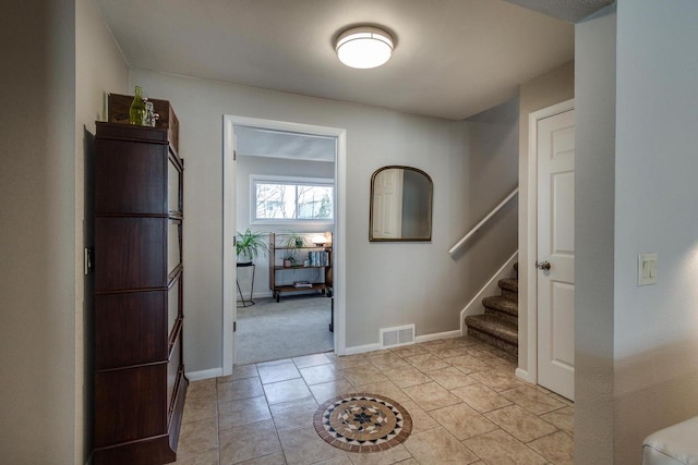 5402 Comanche Way, Madison, WI 53704 - foyer featuring stairs, baseboards, light tile patterned flooring, and light colored carpet