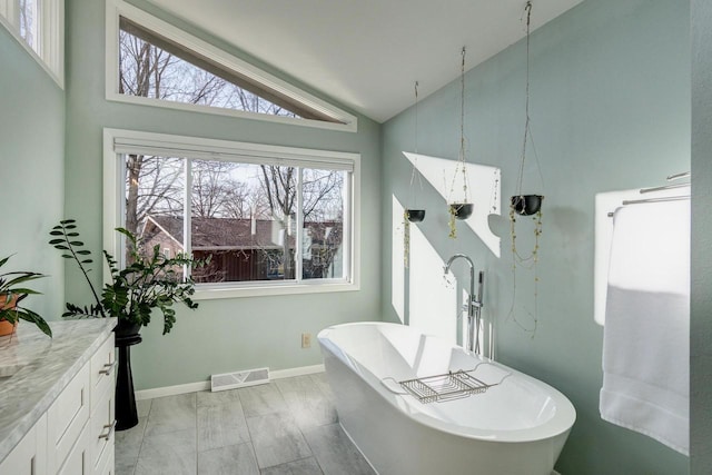 5402 Comanche Way, Madison, WI 53704 - full bathroom featuring a freestanding tub, vanity, high vaulted ceiling, and baseboards