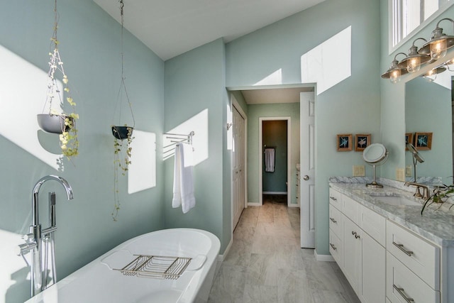 5402 Comanche Way, Madison, WI 53704 - full bath featuring vanity, a soaking tub, a high ceiling, and baseboards